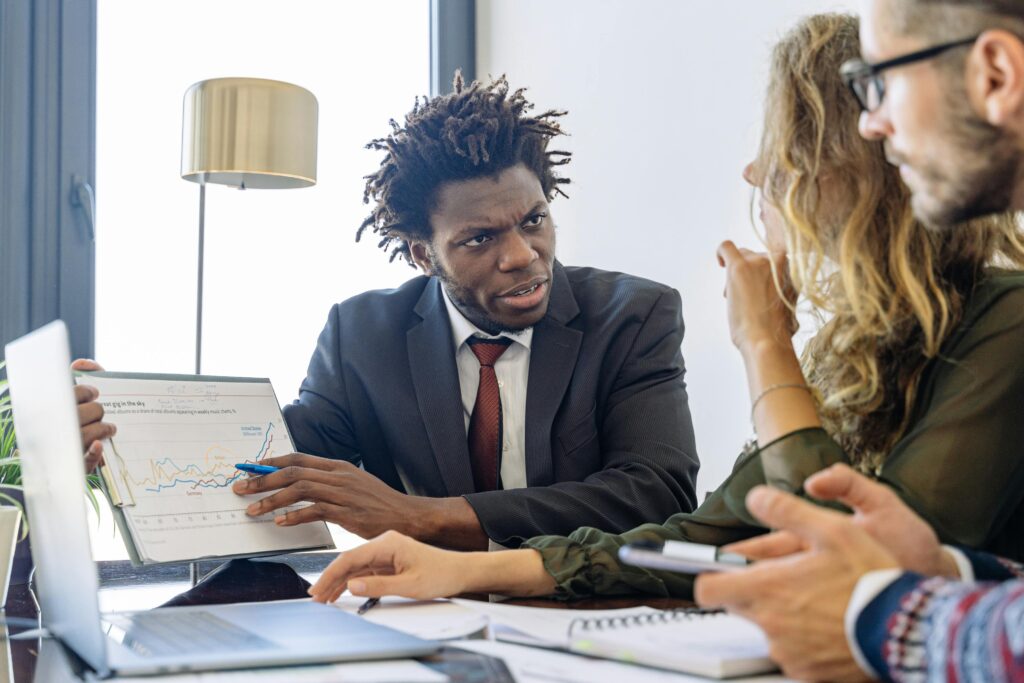 A business development consultant talking to his teammates
