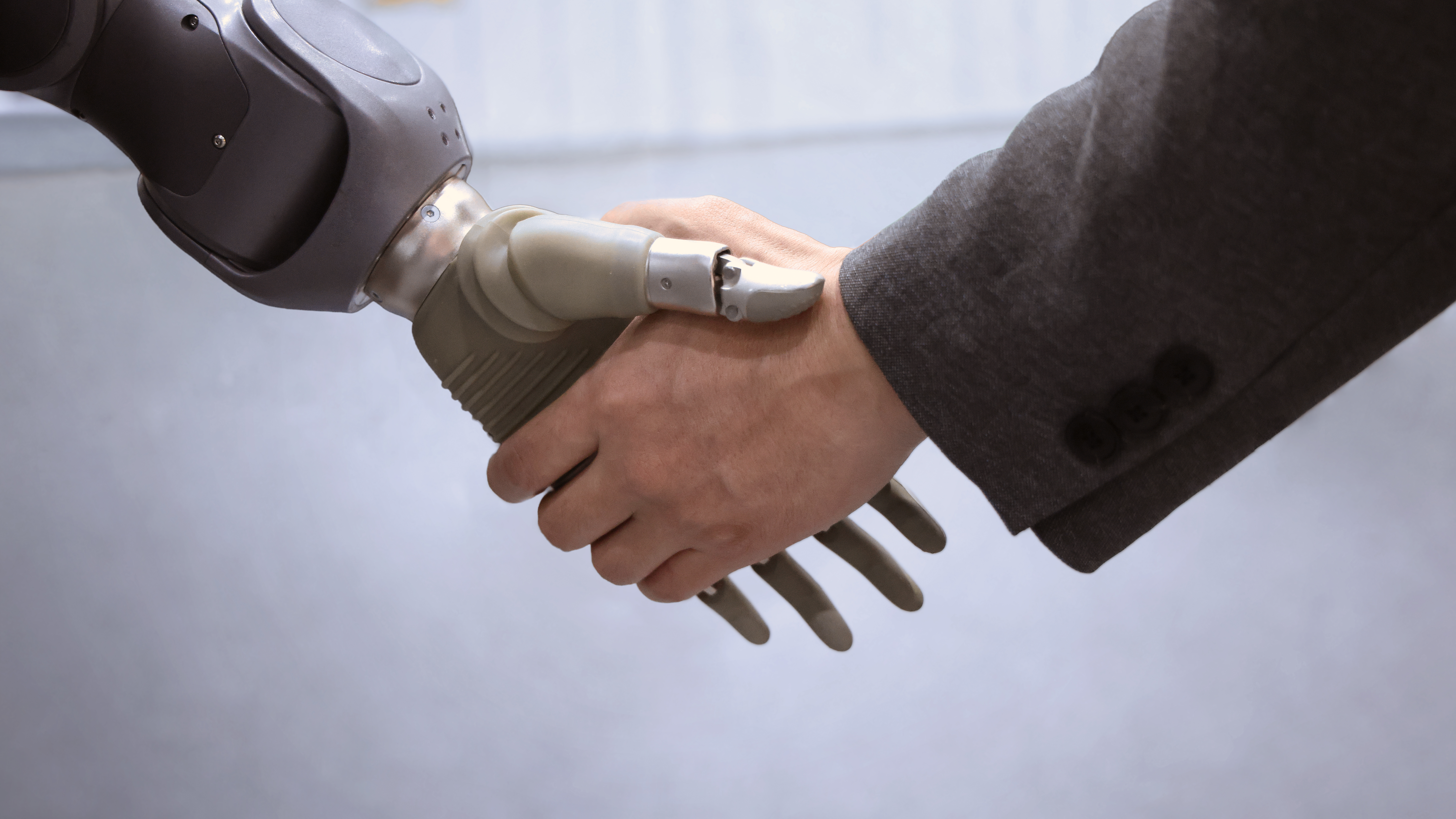 A direct salesperson shaking hands with a robot
